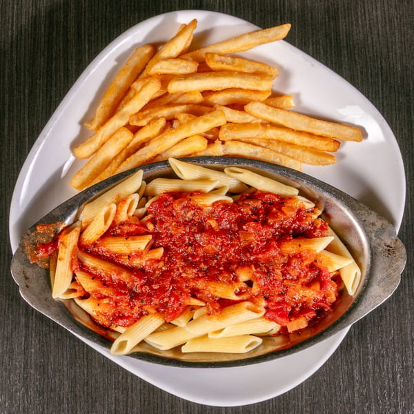 Penne pasta with red sauce in a metal dish, served with a side of golden french fries.